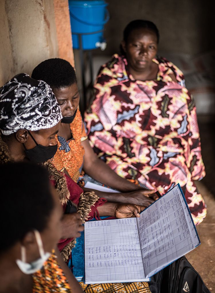 Four women review bookkeeping records in Rwanda.