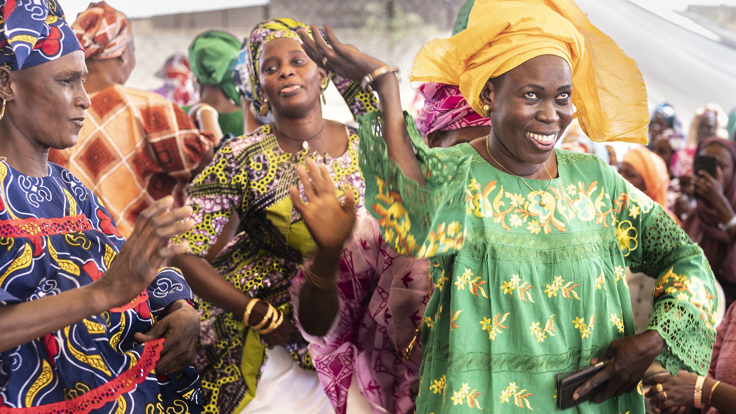 A woman smiling and dancing.